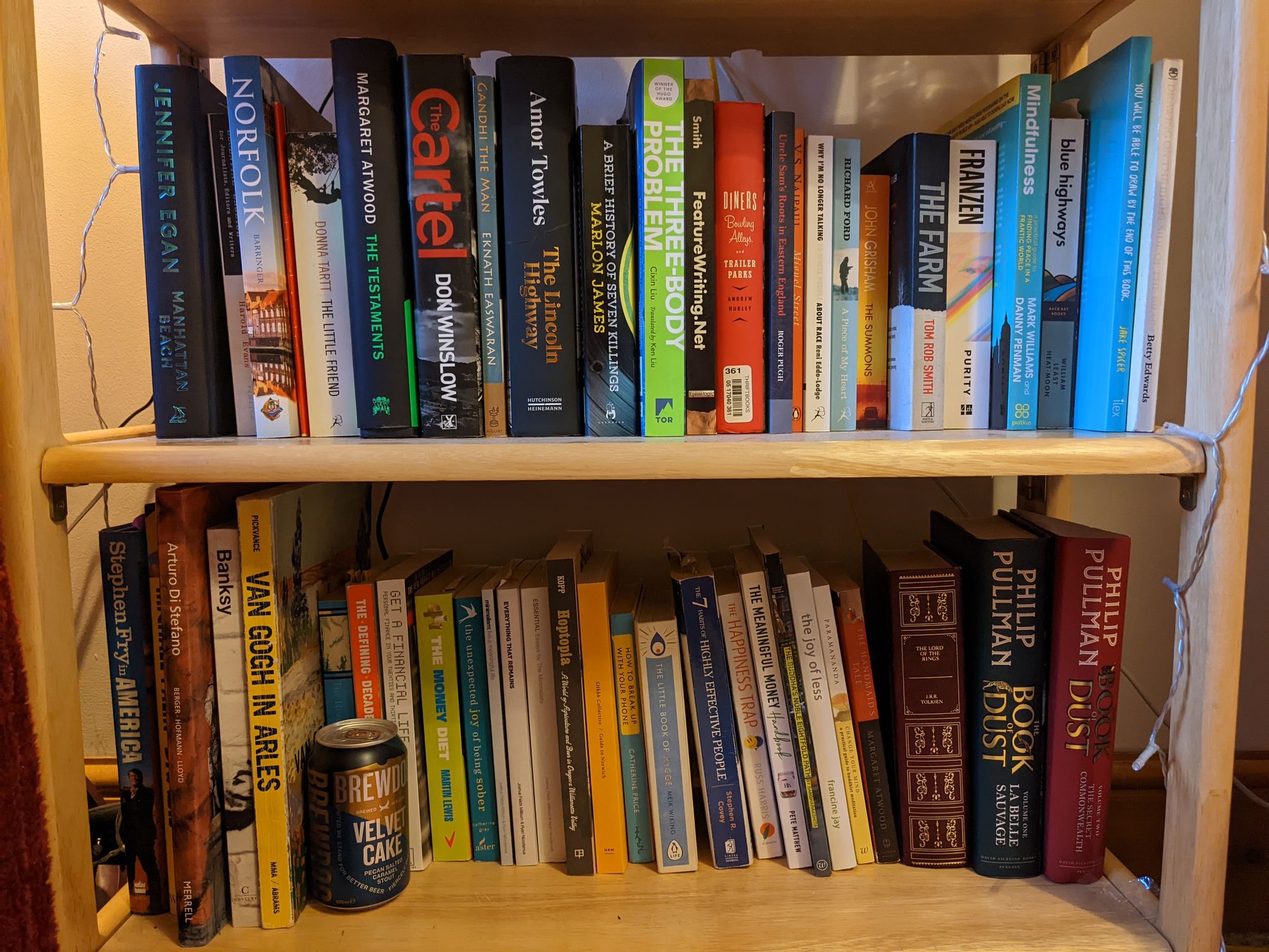 Books on a pine oak shelf.
