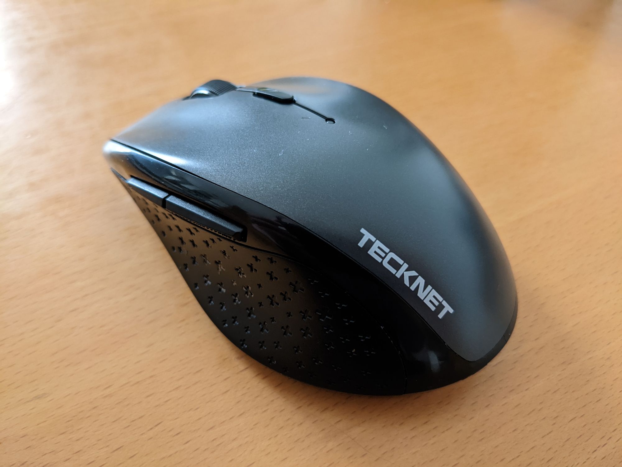 A dark grey computer mouse made by Tecknet