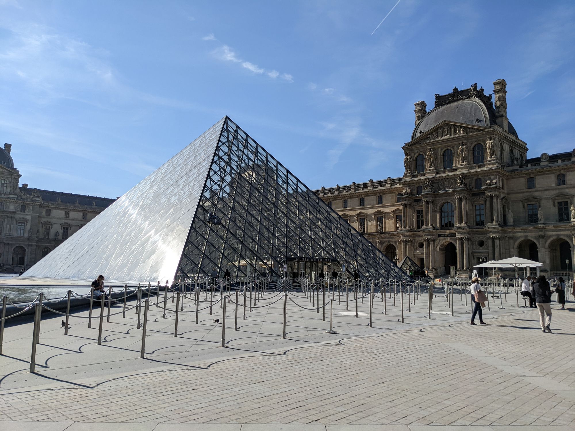 Empty queue lanes outside the Louvre Pyramid entrance in July 2022