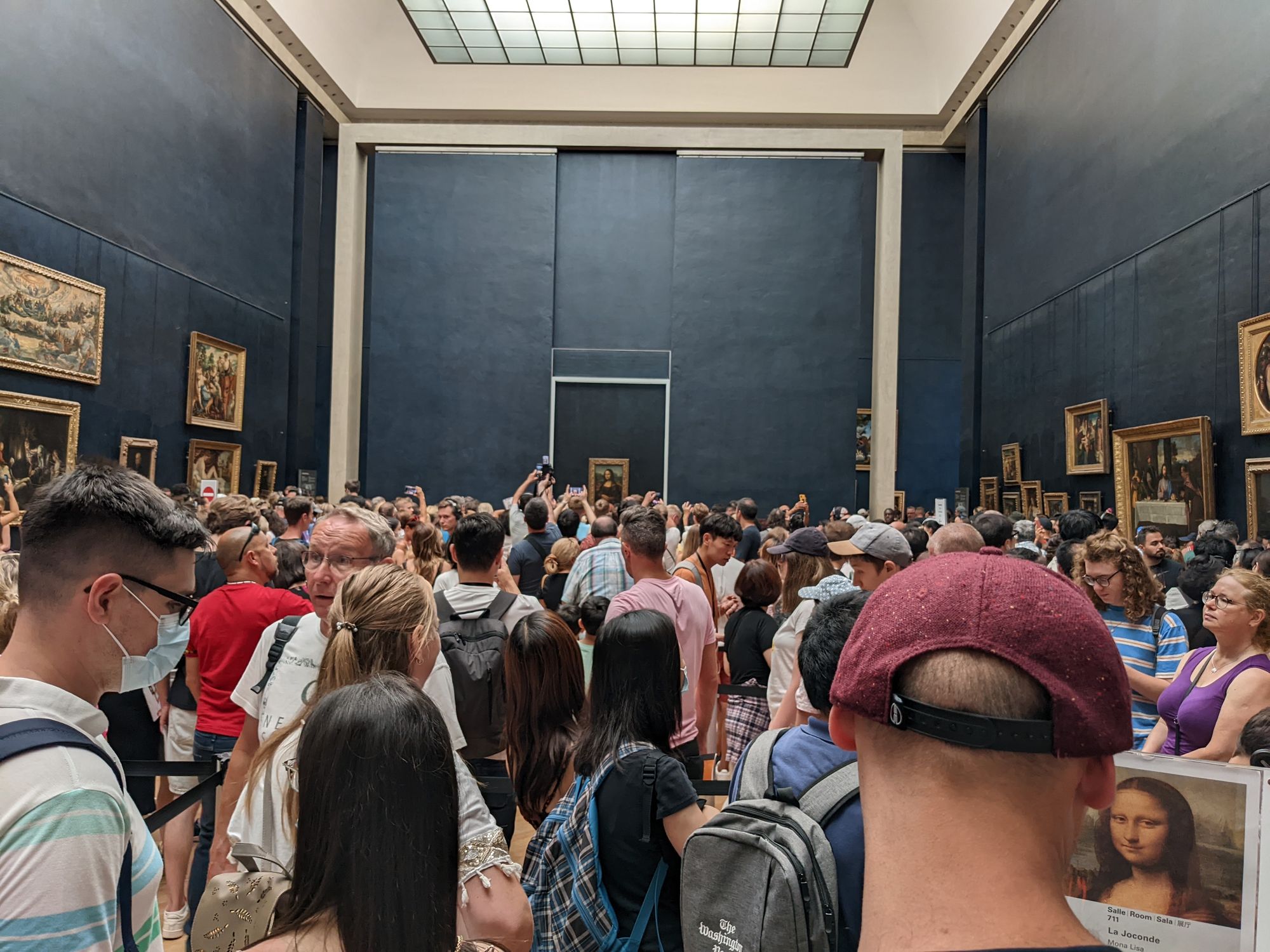 Crowds of people in the Louvre Museum at Paris in front of the Mona Lisa.