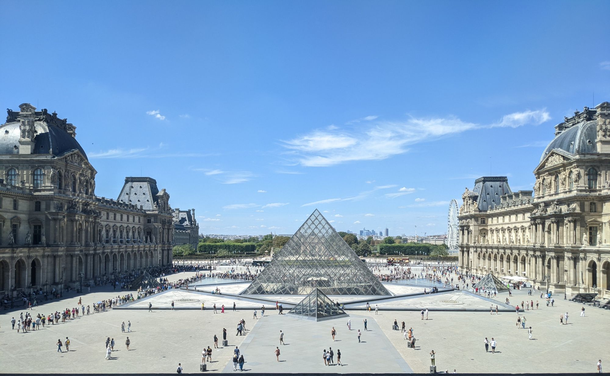 A long queue outside the Louvre Museum near the Pyramid in July 2022